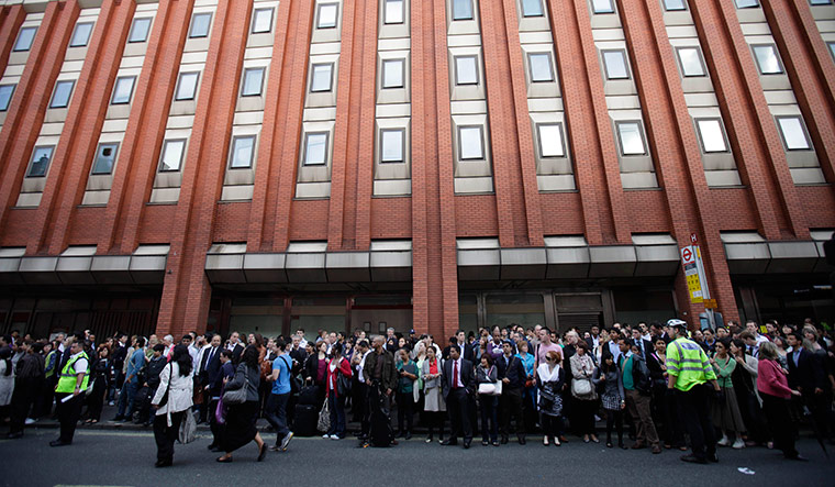 Tube stirke: Commuters wait at a bus stop in central London