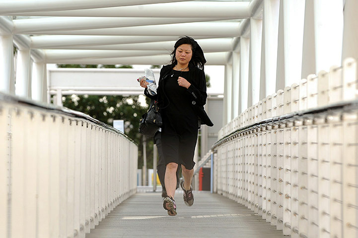 Tube stirke: A woman runs to catch a water taxi