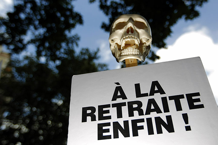 French Strike Update: A skull on the top of a placard reading retired at last in Paris