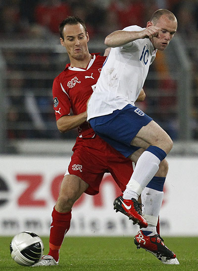 England v Switzerland: Switzerland's von Bergen fights for the ball with England's Rooney