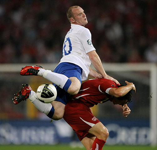 Switzerland v England: England's striker Wayne Rooney is all over Stephan Lichtsteiner