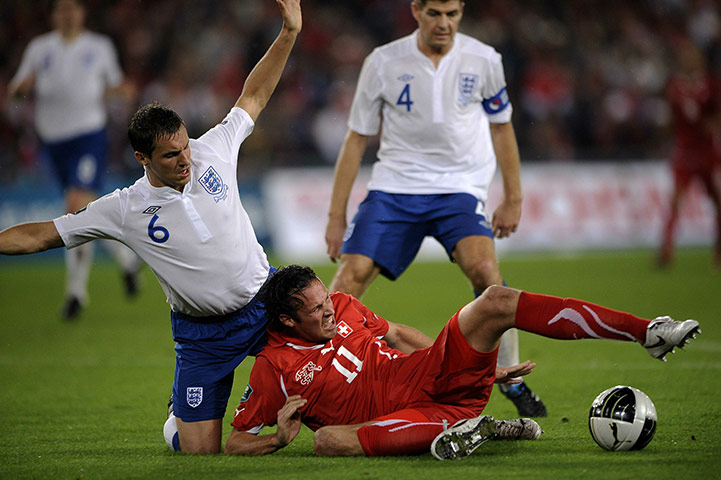 Switzerland v England: Marco Streller grimaces after being tackled by Phil Jagielka tackle