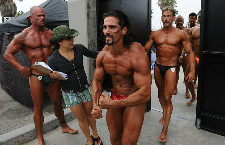 Muscle Beach California: Male bodybuilders leave the stage after the annual Muscle Beach contest, LA