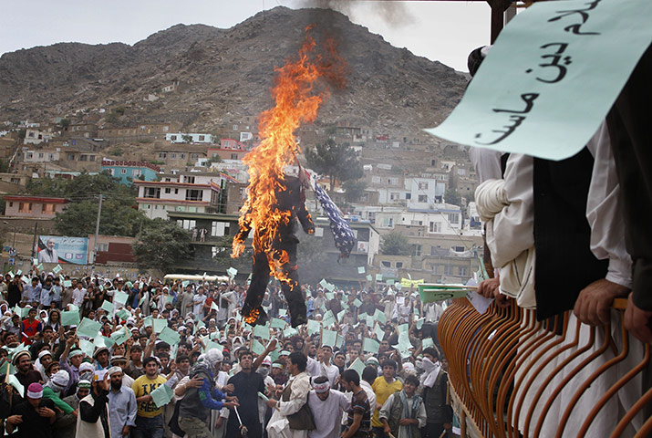 Quran Protest : An Afghani protester burns a portrait of Terry Jones