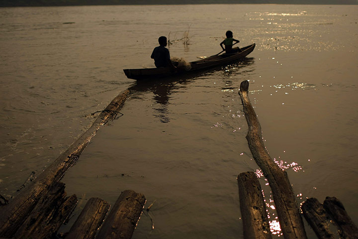 24 hours in pictures: Amacayacu, Colombia: Two indigenous Ticuna people sail the Amazon river 