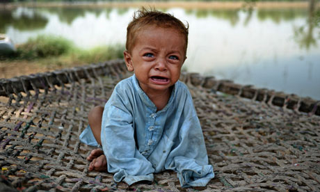 A Pakistani infant displaced by floods cries, Pakistan flooding