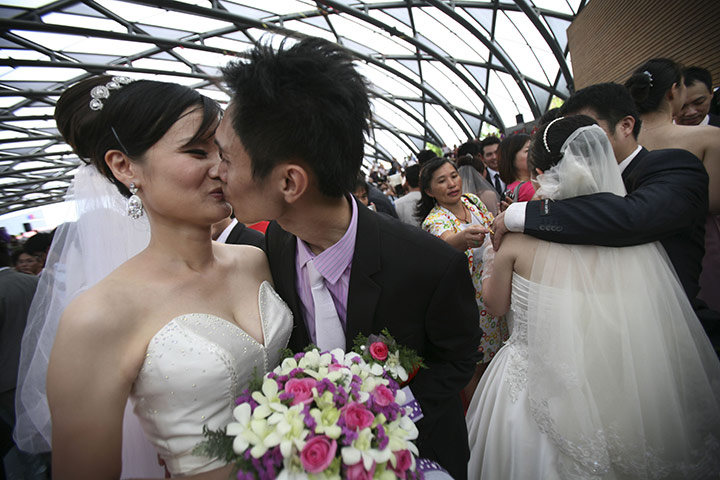 Mass Wedding Taipei: Newly married couples kiss during a mass wedding in Taiwan