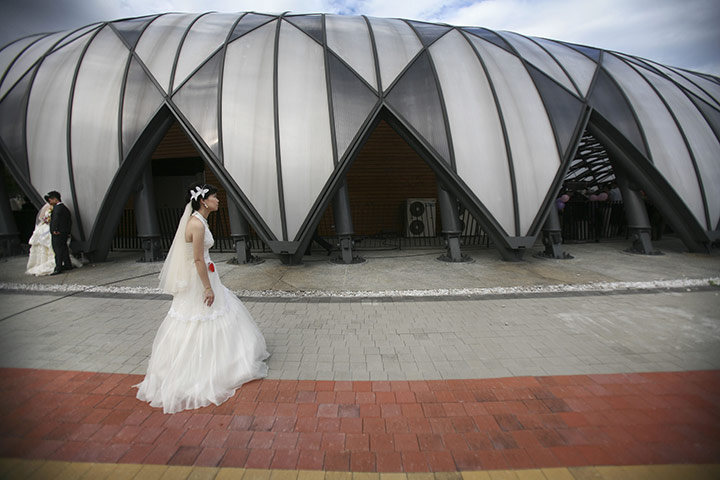 Mass Wedding Taipei: A bride waits for her groom at a mass wedding in Taipei, Taiwan
