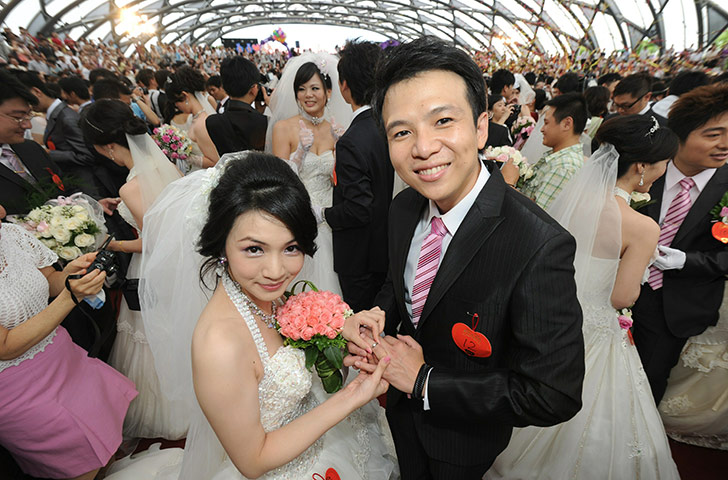 Mass Wedding Taipei: A couple poses for photos during a mass wedding in Taipei