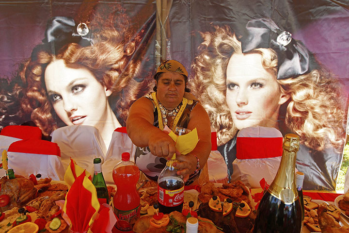 Roma celebrations: A Roma woman opens a soft drink during the annual Roma gathering