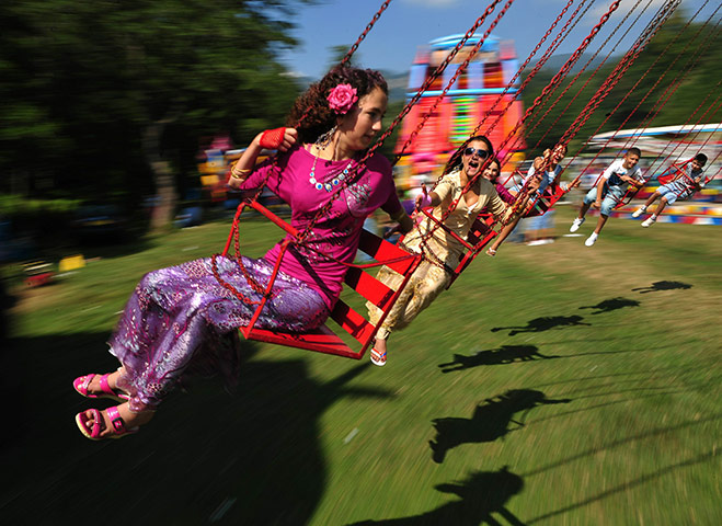 Roma celebrations: Roma girls ride a merry-go-round during celebrations of St Mary's day
