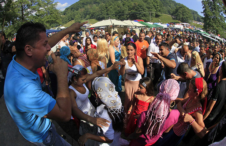 Roma celebrations: Roma people dance in front of a stage