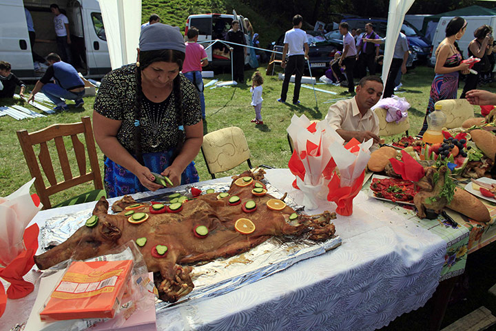 Roma celebrations: A Roma woman decorates a roasted piglet