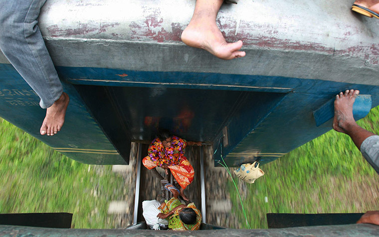 Eid Al-Fitr Festival: Muslims travelling home on the roof of a passenger train Bangladesh