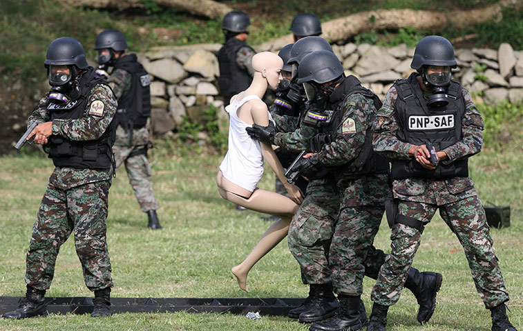 24 hours in pics: Members of the police Special Action Force (SAF) during a simulation