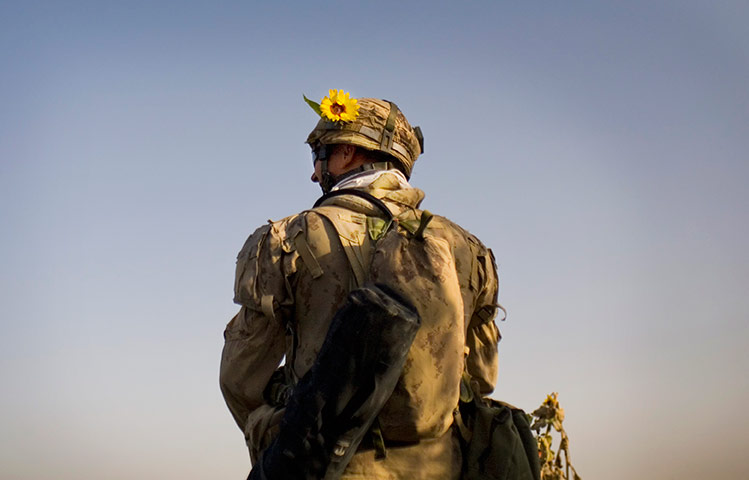 24 hours in pics: A Canadian soldier patrols with a sunflower on helmet in Afghanistan