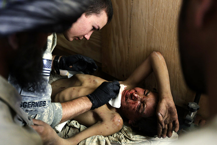24 hours in pics: US medic treats injured Afgan boy, Kandahar