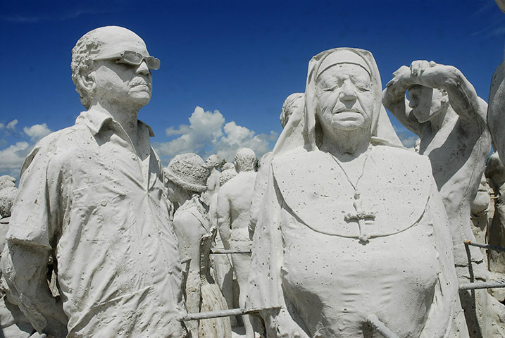 24 hours in pics:  Sculptures by British artist Jason de Caires stand in a beach, Mexico