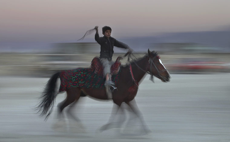 24 Hours in Pics: A young Afghan boy rides on horseback in Kabul