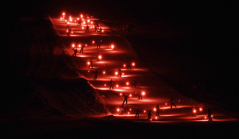 24 Hours in Pics:  Skiers hold flares on a mountain in New Mexico to celebrate the new year