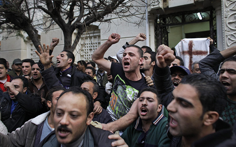24 Hours in Pics: Angry Egyptian Copts shout after a car exploded in front of a church