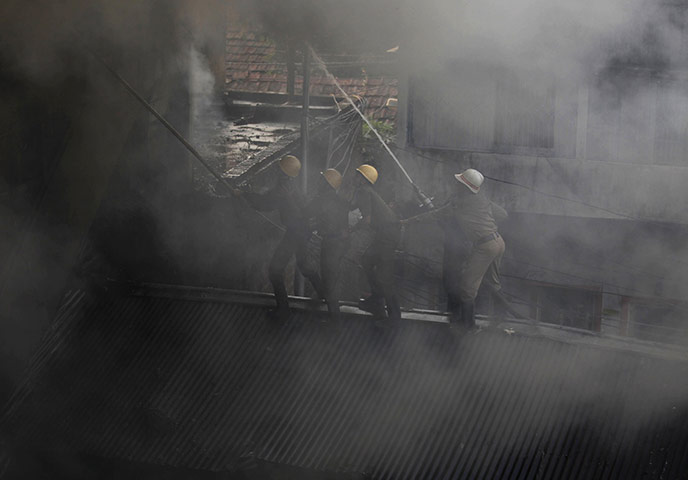 24 hours in pictures: Firefighters try to extinguish a fire in Kolkata
