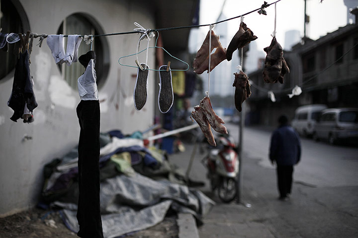 24 hours in pictures: Meat is dried in the sun for Chinese New Year celebrations