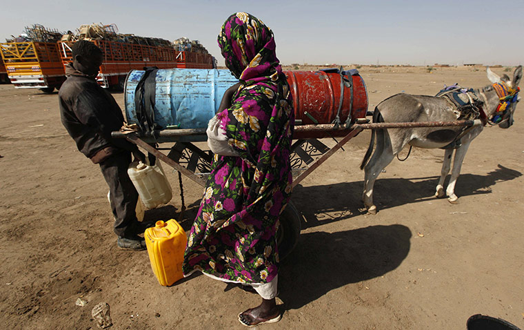 sudan: A Southern Sudanese woman buys drinking water 