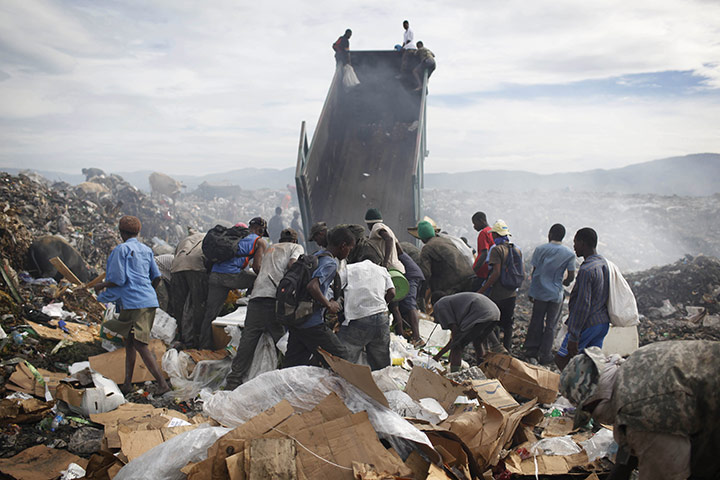 Haiti one year on: June 23: People scavenge for items of value in the rubbish