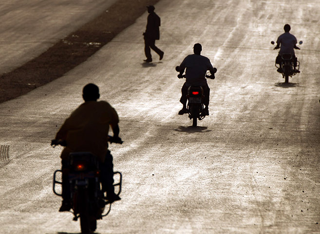 24 hours in pictures: Southern Sudanese men ride motorcycles in Juba