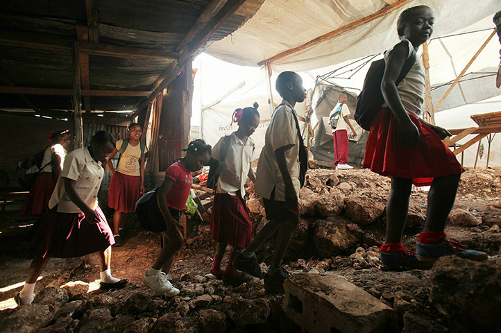 Haiti one year on: January 10, 2011: Pupils walk out of their makeshift classroom 