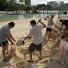 Brisbane floods: Residents use a beach on the banks of the Brisbane River to fill sand bags