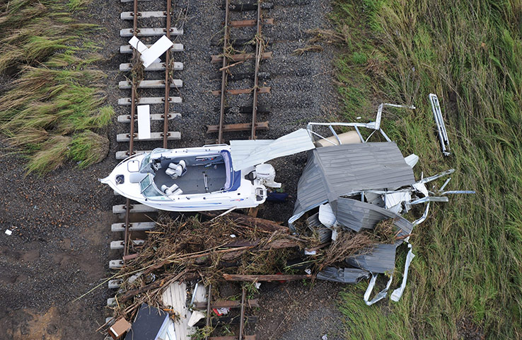 Brisbane floods: A boat sits on rail tracks following flooding in the town of Grantham