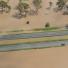 Brisbane floods: A car is stranded in flood waters on the Warrego Highway west of Brisbane