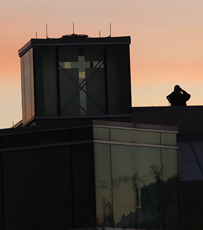 Tuscon shooting: A police officer looks through binoculars from a church building