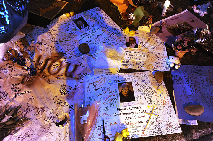 Tuscon shooting: Pictures of victims and notes of condolence left at a makeshift memorial