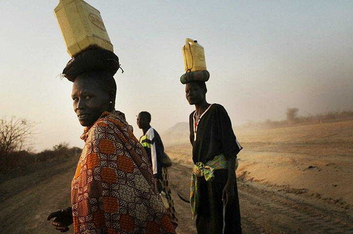 Southern Sudanisn: Women walk home to their village with water, Sudan