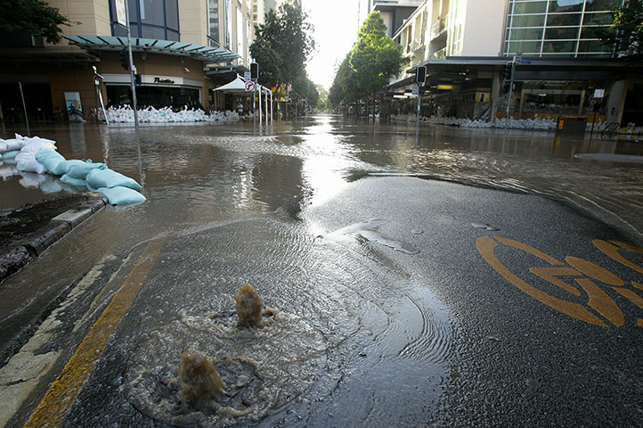 Aerials Brisbane floods: Water bubbles up from drains as parts of the city centre floods in Brisbane