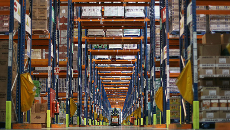 Week in business: A Sainsbury's employee moves Roses chocolates in a warehouse