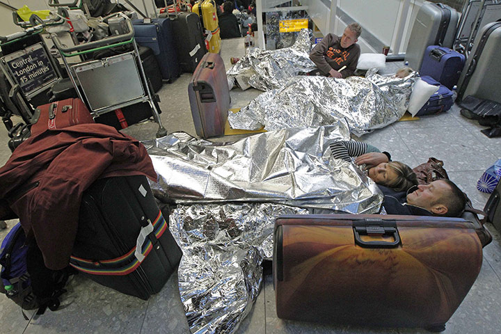 Week in business: Airline passengers lie on the floor in Terminal 3 at Heathrow 