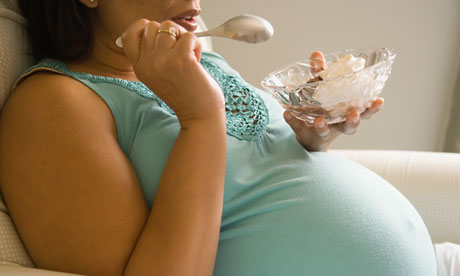 pregnant woman eating. Pregnant woman eating ice