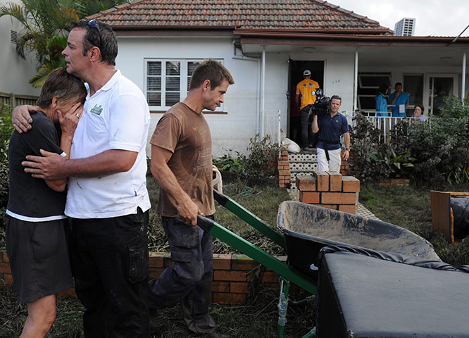 Brisbane Cleanup: Neighbours help with the clean up of the flood damage