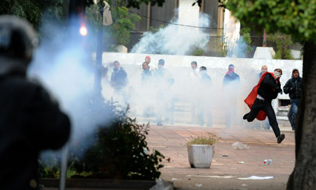 Police and protesters in Tunis exchange volleys of rocks and teargas
