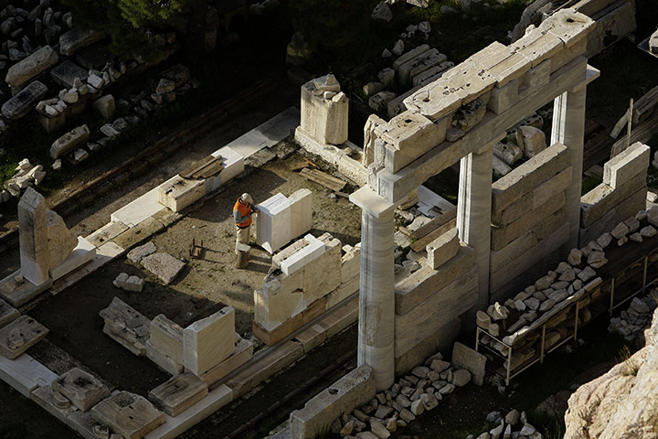24 Hours: A worker during restoration work at the Temple of Asklepios in Athens