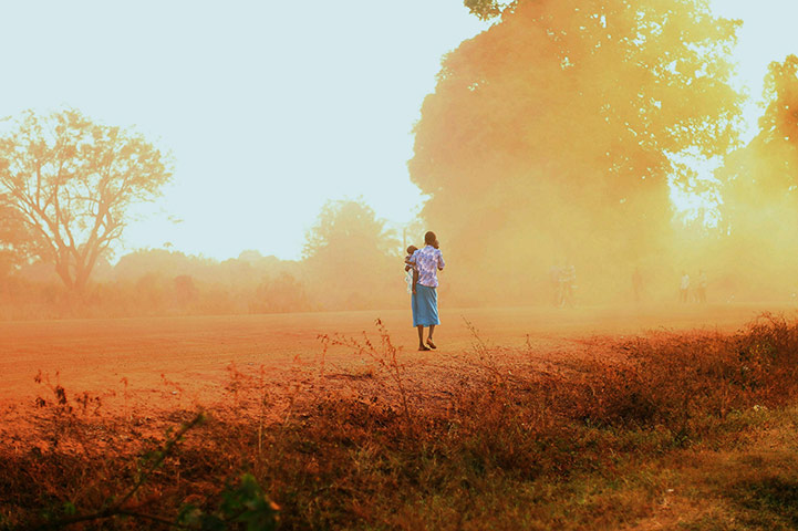 24 Hours: A woman and child walk during the independence referendum vote in Sudan