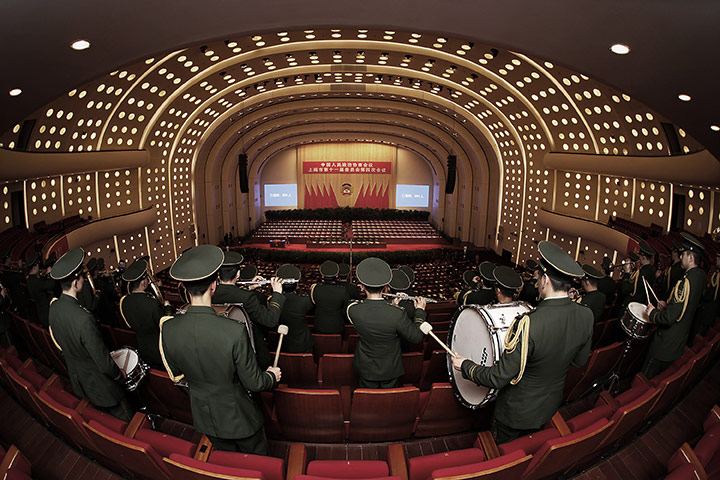24 Hours: A military band play a song at a conference in China