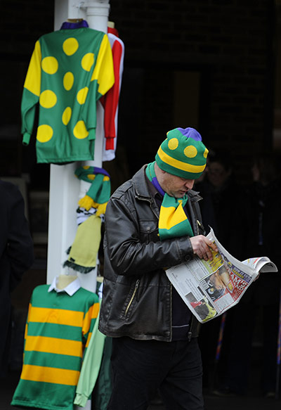 King George VI: Kauto Star fan checks the form in the Racing Post 