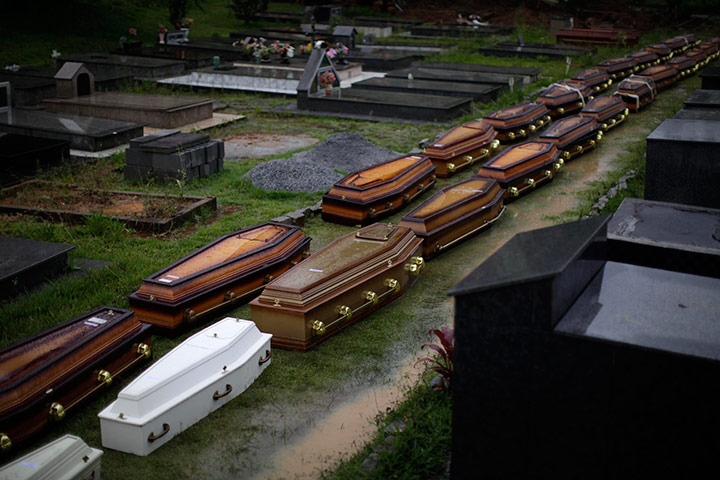 Brazil aftermath: Coffins sit on the floor at a cemetery in Nova Friburgo