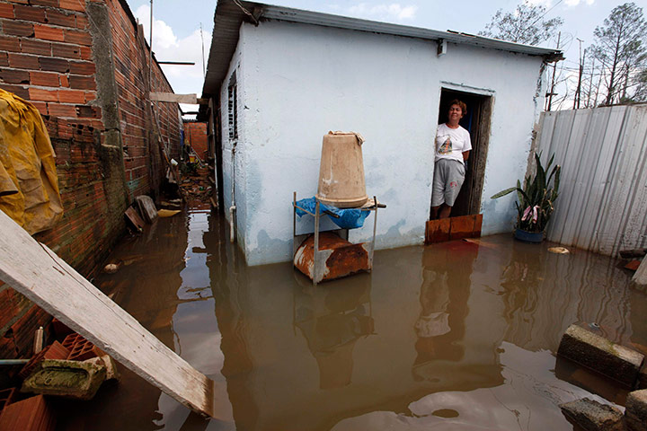 Brazil aftermath: A villager looks on at the entrance of her house in Sao Paulo 