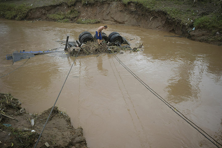 Brazil aftermath: A trucker looks his vehicle from a river, Brazil